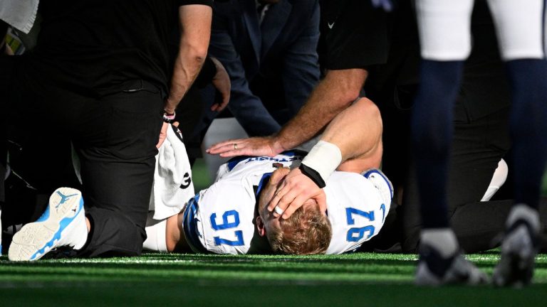 Detroit Lions' Aidan Hutchinson (97) is attended to by staff after suffering an unknown injury int he second half of an NFL football game against the Dallas Cowboys in Arlington, Texas, Sunday, Oct. 13, 2024. (Jerome Miron/AP Photo)