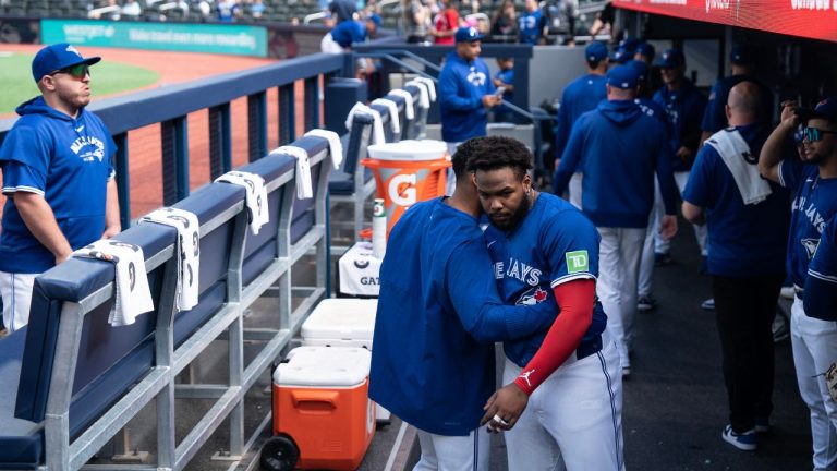 Toronto Blue Jays Vladimir Guerrero Jr. is hugged by a teammate in the dugout before Jays take on the Miami Marlins in interleague baseball action in Toronto, on Sunday, Sept.29, 2024. (Chris Young/CP Photo)