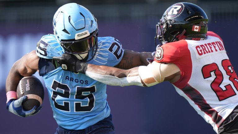 Toronto Argonauts running back Ka'Deem Carey (25) carries the ball against Ottawa Redblacks linebacker Frankie Griffin (28) during first half CFL football action in Toronto on Saturday, Oct. 19, 2024. THE CANADIAN PRESS/Frank Gunn