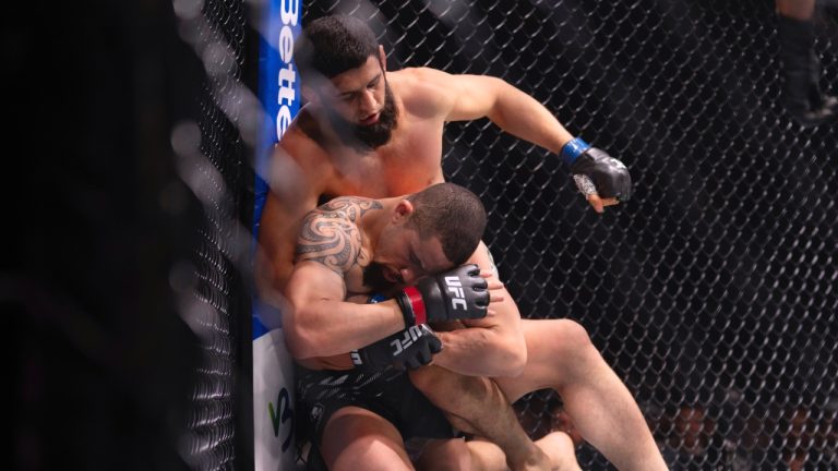 Robert Whittaker is pinned down by Khamzat Chimaev during UFC 308 n Abu Dhabi, United Arab Emirates. (Altaf Qadri/AP)