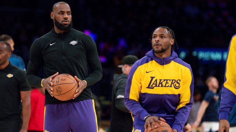 Los Angeles Lakers forward LeBron James, left, and guard Bronny James warm up before an NBA basketball game against the Minnesota Timberwolves, Tuesday, Oct. 22, 2024, in Los Angeles. (AP Photo/Eric Thayer)