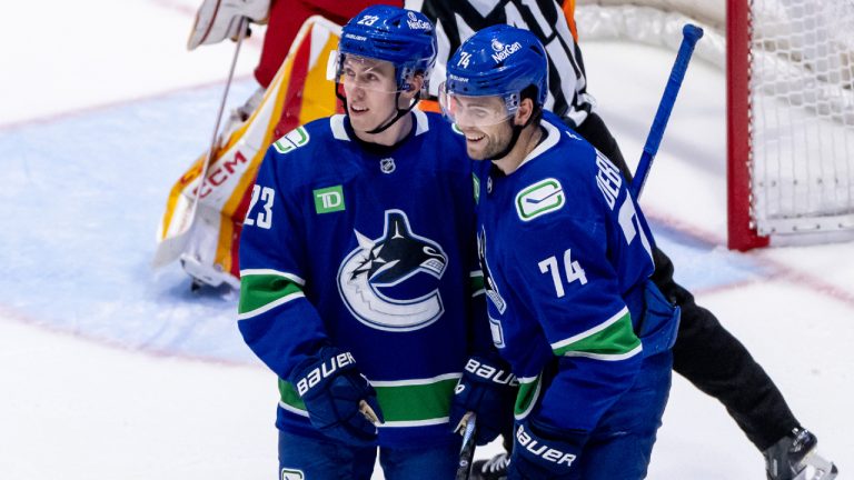 Vancouver Canucks' Jake DeBrusk (74), right, celebrates his goal against the Calgary Flames with Jonathan Lekkerimaki (23) during second period NHL pre-season hockey action in Abbotsford, B.C., on Wednesday September 25, 2024. (Ethan Cairns/CP)