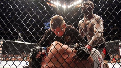 A-mixed-martial-arts-referee-tends-to-the-opponent-of-Jon-Jones-after-a-Jones-TKO-win.