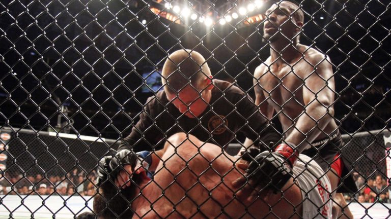 A mixed martial arts referee tends to the opponent of Jon Jones after a Jones TKO win. Jones is known for having some of the best elbows and ground-and-pound in MMA history. (Gregory Payan/AP)