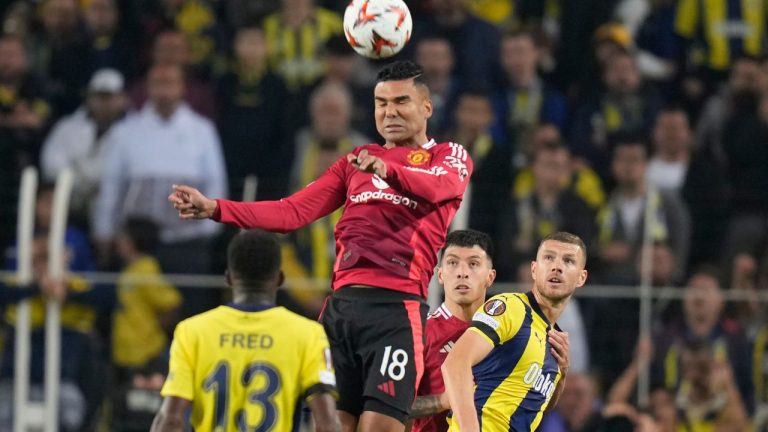 Manchester United's Casemiro, centre, jumps for a header during the Europa League opening phase soccer match between Fenerbahce and Manchester United at Sukru Saracoglu stadium, in Istanbul, Turkey, Thursday, Oct. 24, 2024. (Francisco Seco/AP Photo)