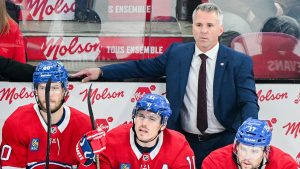 Montreal Canadiens head coach Martin St-Louis looks on from the bench during first period NHL hockey action against the Ottawa Senators in Montreal, Saturday, Oct. 12, 2024. (Graham Hughes/CP)