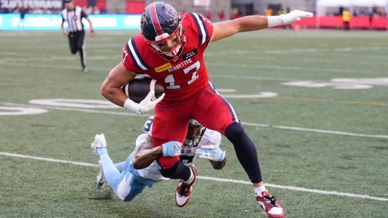 Montreal Alouettes wide receiver Cole Spieker (17) is tackled by Toronto Argonauts defensive back Leonard Johnson (13) during first half CFL football action in Montreal, Thursday, July 11, 2024. (Christinne Muschi/CP)