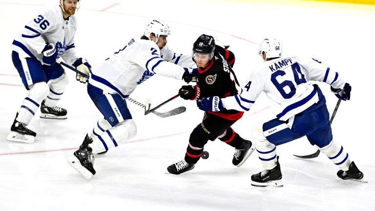 Ottawa Senators' Tim Stutzle (18) tries to maintain possession of the puck as he skates between Toronto Maple Leafs' Dakota Mermis (36), Simon Benoit (2) and David Kampf (64), during third period NHL pre-season hockey action in Ottawa, on Tuesday, Sept. 24, 2024. (Justin Tang/CP)