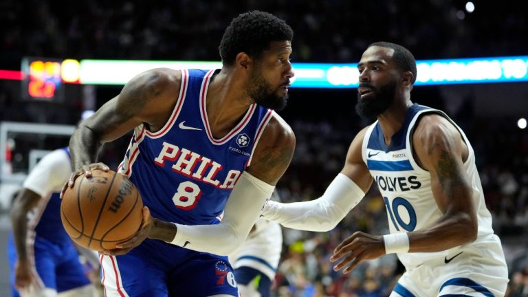 Philadelphia 76ers forward Paul George (8) looks to drive around Minnesota Timberwolves guard Mike Conley (10) during the first half of an NBA pre-season basketball game on Friday, Oct. 11, 2024, in Des Moines, Iowa. (AP/Charlie Neibergall)