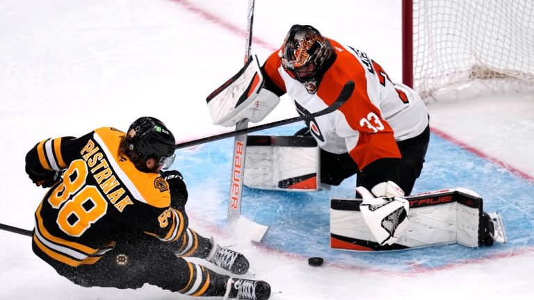 Philadelphia Flyers goaltender Samuel Ersson (33) drops to the ice to make a save on a shot by Boston Bruins right wing David Pastrnak (88) during the first period of an NHL hockey game, Tuesday, Oct. 29, 2024, in Foxborough, Mass. (Charles Krupa/AP)