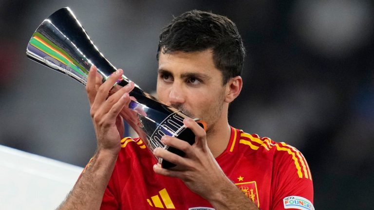 Spain's Rodri kisses his Best Player of the tournament trophy after the final match between Spain and England at the Euro 2024 soccer tournament in Berlin, Germany, Sunday, July 14, 2024. Spain won 2-1. (Manu Fernandez/AP Photo)