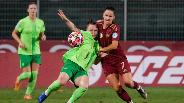 Wolfsburg's Marina Hegering, left, and AS Roma's Evelyne Viens battle for the ball during a women's Champions League Group A game between AS Roma and Wolfsburg at the Tre Fontane stadium in Rome, Tuesday, Oct. 8, 2024. (Fabrizio Corradetti/LaPresse via AP)