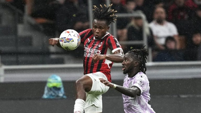 AC Milan's Samuel Chukwueze, left, and Udinese's Jordan Zemura challenge for the ball during the Serie A soccer match between AC Milan and Udinese. (Antonio Calanni/AP)