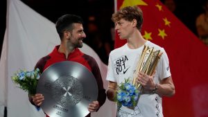 Jannik Sinner of Italy, right, chats with Novak Djokovic of Serbia during a trophy ceremony after their men's singles finals match for the Shanghai Masters tennis tournament at Qizhong Forest Sports City Tennis Center in Shanghai, China, Sunday, Oct. 13, 2024. (AP/Andy Wong)