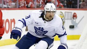 New Jersey Devils right wing Timo Meier (28) controls the puck past Toronto Maple Leafs defenseman Chris Tanev (8) during the second period of an NHL hockey game Thursday, Oct. 10, 2024, in Newark, N.J. (Adam Hunger/AP Photo)