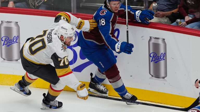 Vegas Golden Knights winger Tanner Pearson, left, checks Colorado Avalanche defenceman Jack Ahcan as they pursue the puck in the first period of an NHL preseason hockey game Tuesday, Oct. 1, 2024, in Denver. (David Zalubowski/AP)