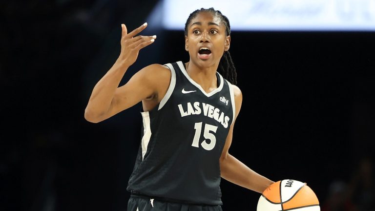 Las Vegas Aces guard Tiffany Hayes (15) signals during a first-round WNBA basketball playoff game against the Seattle Storm, Sunday, Sept. 22, 2024, in Las Vegas. (AP Photo/Ronda Churchill)