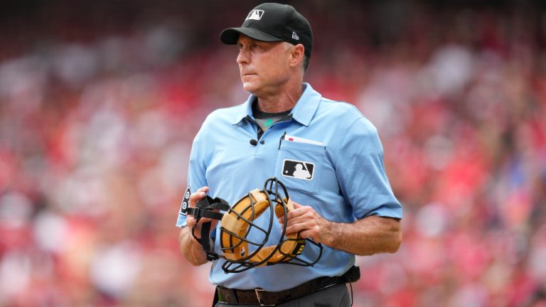 Umpire Dan Iassogna (58) stands at home plate during a baseball game between the San Francisco Giants and the Cincinnati Reds Thursday, July 20, 2023, in Cincinnati. (Jeff Dean/AP)