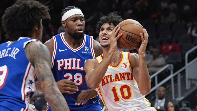 Atlanta Hawks forward Zaccharie Risacher (10) tries to get past Philadelphia 76ers forward Guerschon Yabusele (28) in the first half of a preseason NBA basketball game. (John Bazemore/AP)
