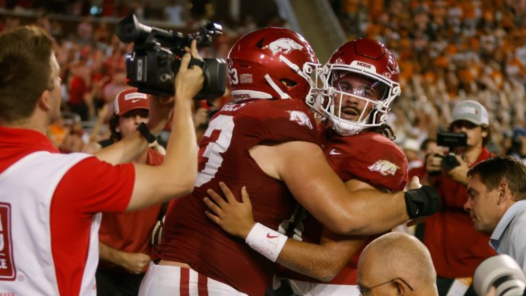 Arkansas quarterback Malachi Singleton celebrates his game-winning touchdown with offensive lineman Addison Nichols (63) during the fourth quarter of an NCAA football game against Tennessee on Saturday, Oct. 5, 2024, in Fayetteville, Ark. Arkansas won 19-14. (Mike Buscher/AP Photo)