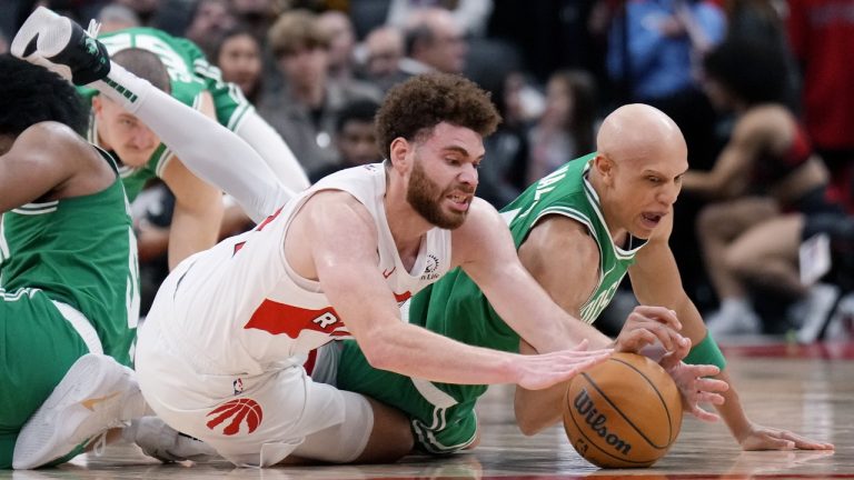 Toronto Raptors forward Jamison Battle (77) and Boston Celtics guard Jordan Walsh (27) battle for the ball during second half NBA pre-season basketball action in Toronto on Tuesday, October 15, 2024. (Nathan Denette/CP)