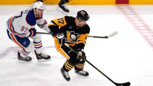 Pittsburgh Penguins' Sidney Crosby (87) skates past Edmonton Oilers' Connor McDavid during the first period of an NHL hockey game in Pittsburgh, Sunday, March 10, 2024. (Gene J. Puskar/AP Photo)