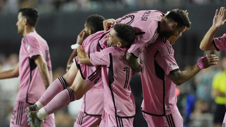 Inter Miami defender Jordi Alba (18) lifts Inter Miami forward Lionel Messi (10) after Alba scored a goal during the second half of match one of their MLS playoff opening round soccer match against Atlanta United. (Rebecca Blackwell/AP)