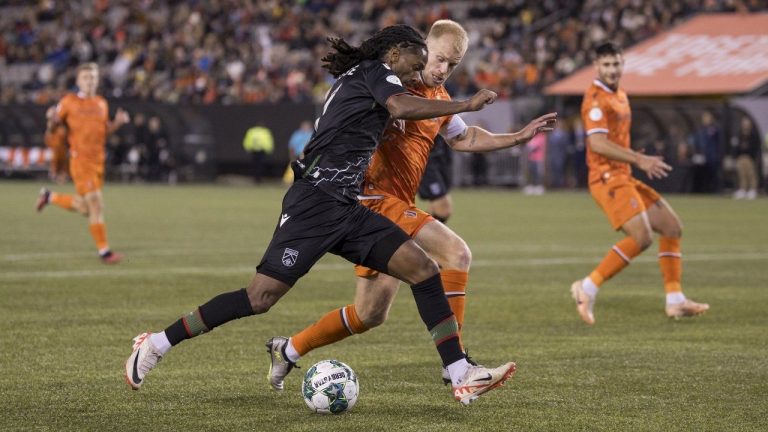 Forge FC midfielder Kyle Bekker (right) and Cavalry FC forward Ali Musse (7) battle for the ball during first half Canadian Premier League finals soccer action in Hamilton on Saturday, Oct. 28, 2023. (Nick Iwanyshyn/CP)