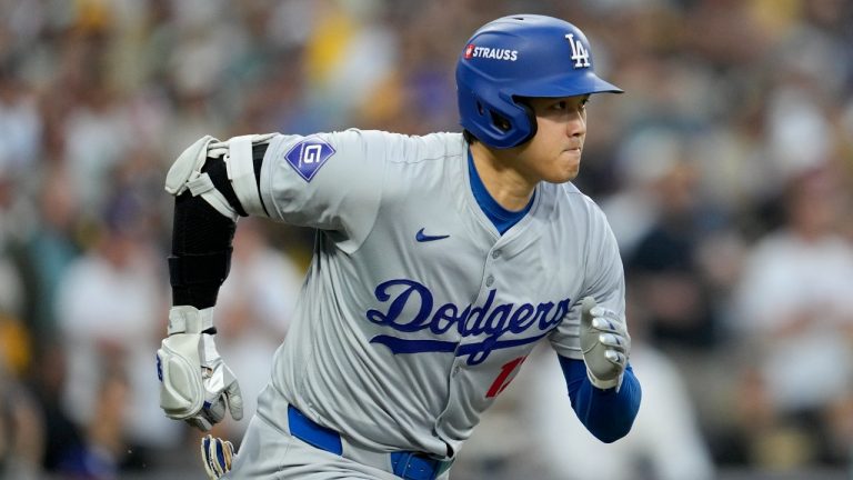 Los Angeles Dodgers' Shohei Ohtani runs to first base as he grounds out during the first inning in Game 4 of a baseball NL Division Series against the San Diego Padres, Wednesday, Oct. 9, 2024, in San Diego. (Ashley Landis/AP)