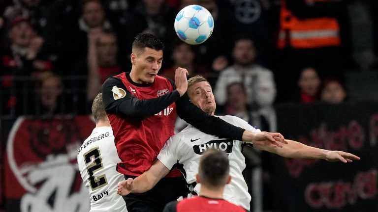 Leverkusen's Patrik Schick, up, and Carlo Sickinger of Elversberg challenge for the ball during the German Soccer Cup match between Bayer Leverkusen and SV Elversberg at the BayArena in Leverkusen, Germany, Tuesday, Oct. 29, 2024. (Martin Meissner/AP)