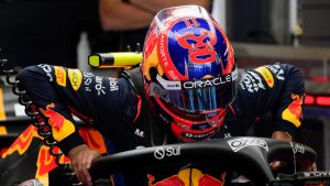 Red Bull driver Sergio Perez, of Mexico, slips into his car during the first free practice ahead of the Formula One Mexico Grand Prix auto race at the Hermanos Rodriguez racetrack. (Moises Castillo/AP)