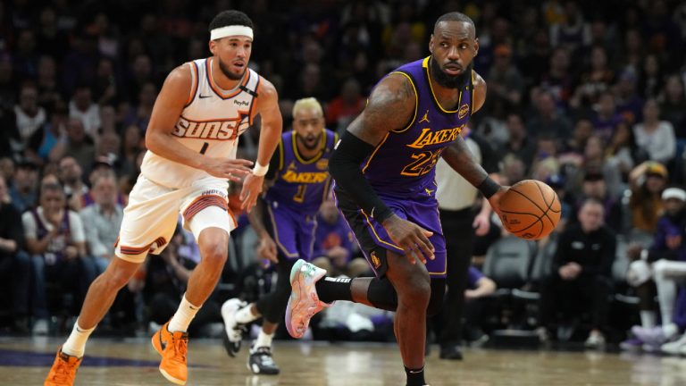 Los Angeles Lakers forward LeBron James (23) drives past Phoenix Suns guard Devin Booker (1) during the second half of an NBA basketball game, Monday, Oct. 28, 2024, in Phoenix. Phoenix won 109-105. (Rick Scuteri/AP)