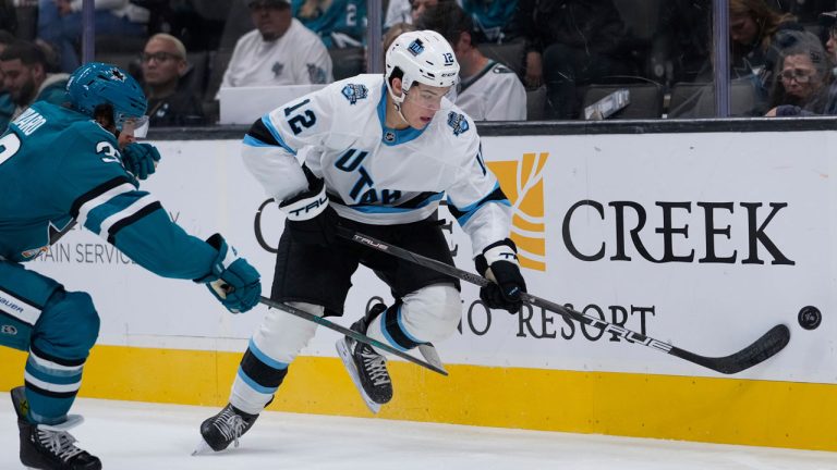 Utah Hockey Club forward Tij Iginla (12) moves the puck against San Jose Sharks defenseman Mario Ferraro during the second period of a pre-season NHL hockey game. (Godofredo A. Vásquez/AP)