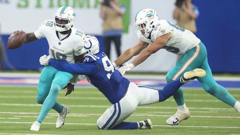 Indianapolis Colts defensive end Laiatu Latu (97) Sacks Miami Dolphins quarterback Tyler Huntley (18) as tight end Julian Hill, right attempts to stop him during the second half of an NFL football game. (Michael Conroy/AP)
