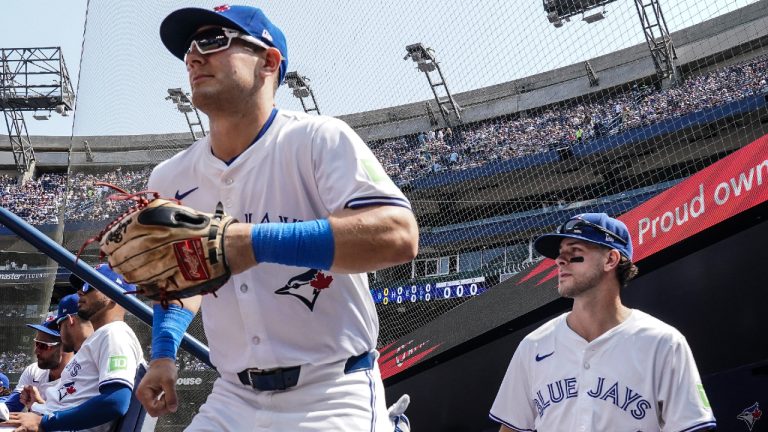 Toronto Blue Jays' Daulton Varsho and Ernie Clement take to the field before American League MLB baseball action against the Texas Rangers in Toronto on Saturday, July 27, 2024. (Chris Young/CP)