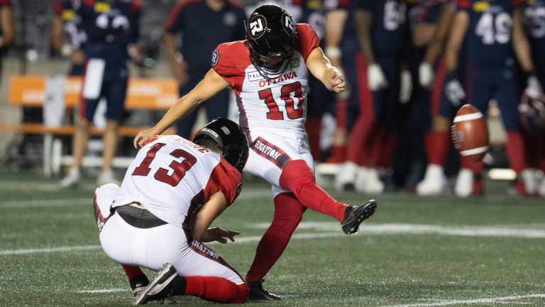 Otaawa Redblacks kicker Lewis Ward attempts a field goal with Richie Leone (left) during CFL pre-season action against the Montreal Alouettes Friday, May 31, 2024 in Ottawa. (Adrian Wyld/CP)