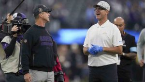 Los Angeles Chargers head coach Jim Harbaugh, right, talks to his brother, Baltimore Ravens Head Coach John Harbaugh, before an NFL football game Monday, Nov. 25, 2024, in Inglewood, Calif. (Eric Thayer/AP)