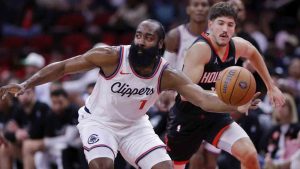 Los Angeles Clippers guard James Harden (1) scoops up the ball in front of Houston Rockets guard Reed Sheppard, right, during the first half of an Emirates NBA Cup basketball game Friday, Nov. 15, 2024, in Houston. (Michael Wyke/AP)