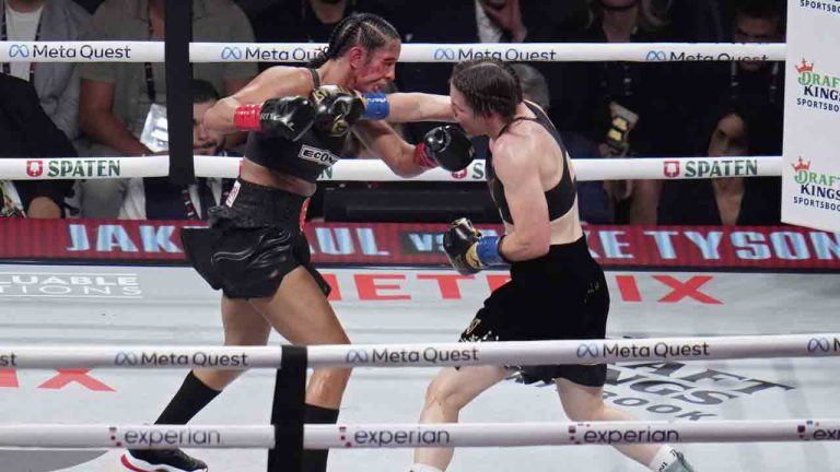 Katie Taylor, right, lands a right to Amanda Serrano during their undisputed super lightweight title bout, Friday, Nov. 15, 2024, in Arlington, Texas. (Julio Cortez/AP)