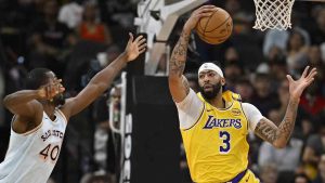 Los Angeles Lakers' Anthony Davis (3) grabs the rebound ahead of San Antonio Spurs' Harrison Barnes during the first half of an NBA basketball game, Wednesday, Nov. 27, 2024, in San Antonio. (Darren Abate/AP)