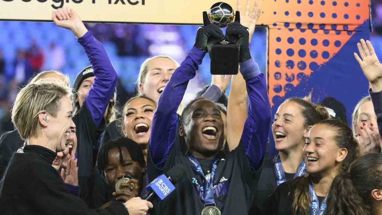 Orlando Pride forward Barbra Banda, centre, raises her MVP trophy after the team defeated the Washington Spirit in the NWSL championship soccer game at CPKC Stadium, Saturday, Nov. 23, 2024, in Kansas City, Mo. (Reed Hoffmann/AP)