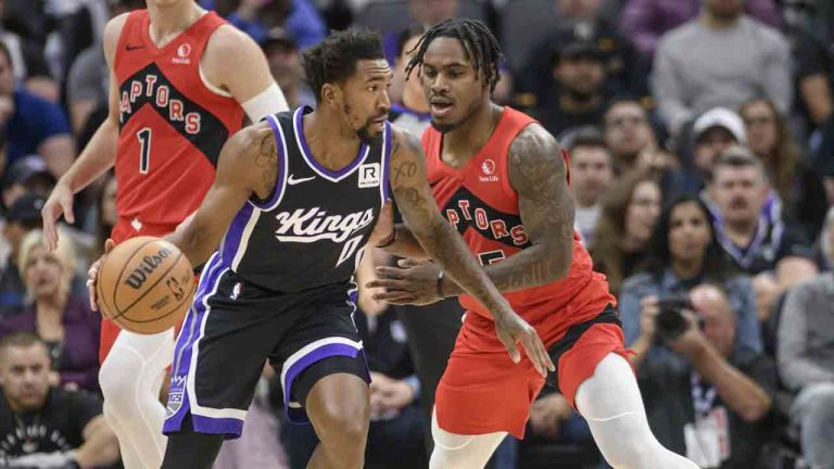 Sacramento Kings guard Malik Monk (0) is guarded by Toronto Raptors guard Davion Mitchell during the first half of an NBA basketball game in Sacramento, Calif., Wednesday, Nov. 6, 2024. (Randall Benton/AP)