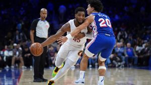 Cleveland Cavaliers' Donovan Mitchell, left, tries to get past Philadelphia 76ers' Jared McCain during the second half of an NBA basketball game, Wednesday, Nov. 13, 2024, in Philadelphia. (AP Photo/Matt Slocum)