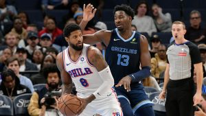 Philadelphia 76ers forward Paul George (8) handles the ball against Memphis Grizzlies forward Jaren Jackson Jr. (13) in the first half of an NBA basketball game Wednesday, Nov. 20, 2024, in Memphis, Tenn. (AP Photo/Brandon Dill)