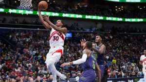 Toronto Raptors guard Ochai Agbaji (30) goes to the basket ahead of New Orleans Pelicans center Yves Missi (21) and guard Dejounte Murray (5) in the first half of an NBA basketball game in New Orleans, Wednesday, Nov. 27, 2024. (Gerald Herbert/AP)