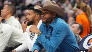 Toronto Raptors forward Bruce Brown, front, joins forward Garrett Temple in looking on from the bench in the second half of an NBA basketball game against the Denver Nuggets, Monday, Nov. 4, 2024, in Denver. (David Zalubowski/AP)