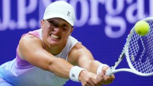 Iga Swiatek, of Poland, reaches out to hit a return to Jessica Pegula, of the United States, during the quarterfinals of the U.S. Open tennis tournament, Wednesday, Sept. 4, 2024, in New York. (AP Photo/Eduardo Munoz Alvarez) 