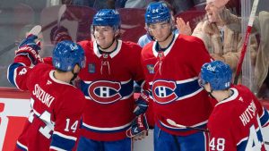 Montreal Canadiens' Cole Caufield (13) celebrates with teammates Nick Suzuki (14), Logan Mailloux (24) and Lane Hutson (48) after scoring during third period NHL hockey action against the St. Louis Blues Saturday, October 26, 2024 in Montreal. (Ryan Remiorz/CP)