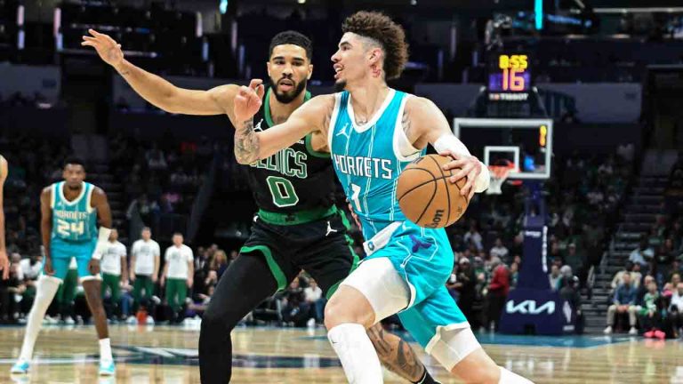 Charlotte Hornets guard LaMelo Ball (1) drives to the basket against Boston Celtics forward Jayson Tatum (0) during the first half of an NBA basketball game, Saturday, Nov. 2, 2024, in Charlotte, N.C. (Matt Kelley/AP)