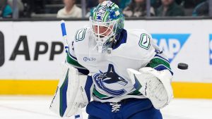 Vancouver Canucks goaltender Kevin Lankinen (32) blocks a shot against the San Jose Sharks during the first period of an NHL hockey game in San Jose, Calif., Saturday, Nov. 2, 2024. (Tony Avelar/AP) 